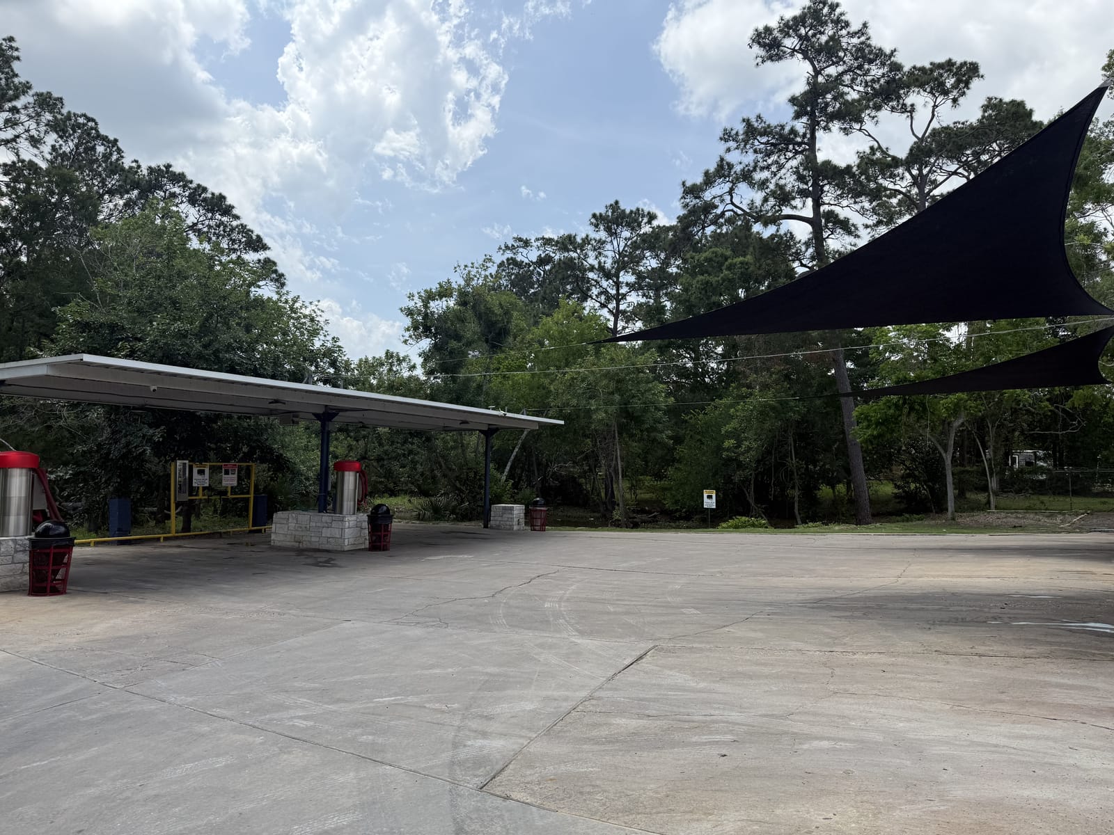 Vacuum stations at Gilbert's Car Wash Dickinson — covered stalls with high-powered vacuums