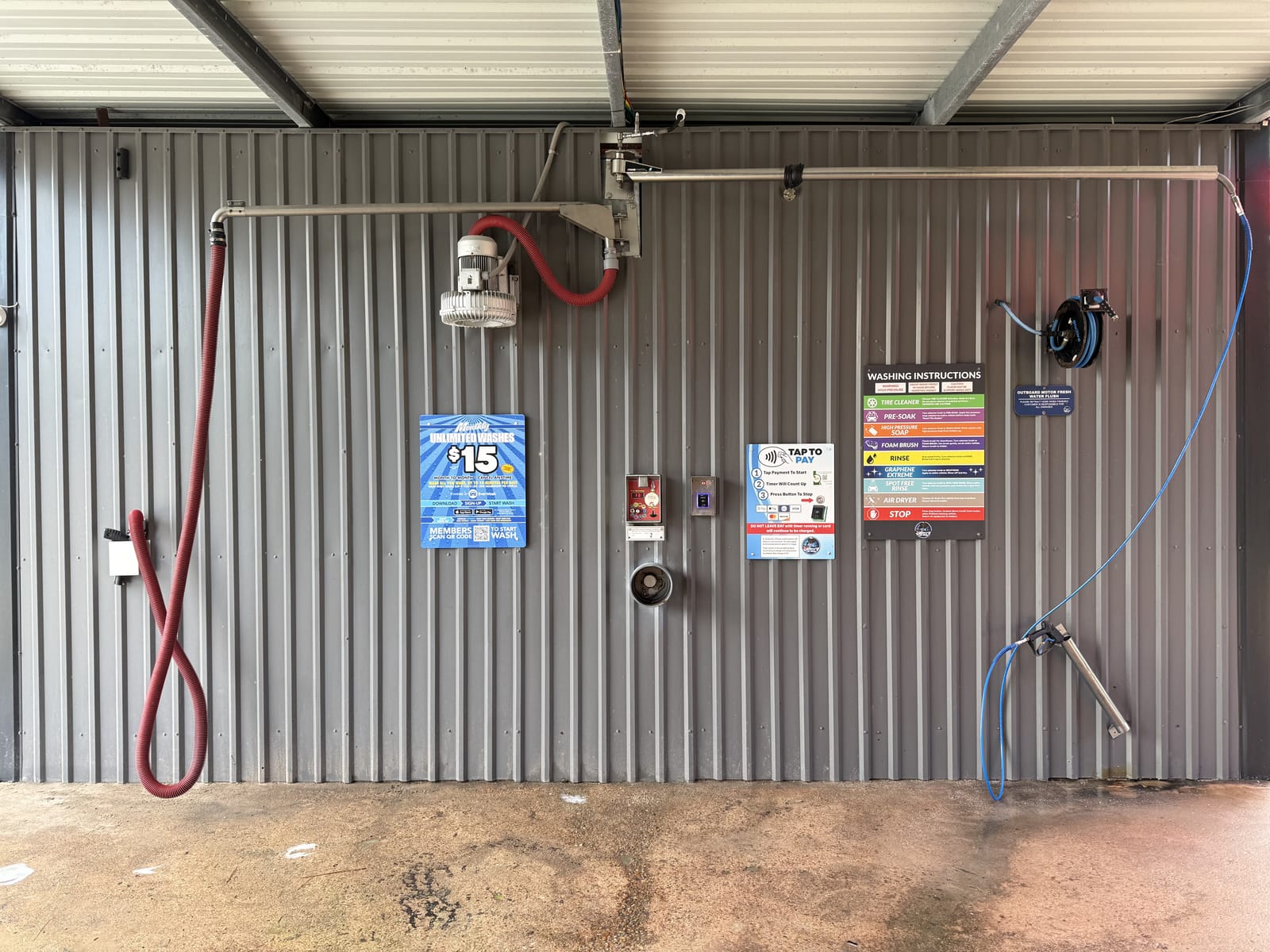 Self-serve wash bay at Gilbert's Car Wash Dickinson — high-pressure wand and foaming brush